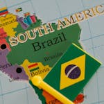 Detailed close-up of Brazil on a map with a Brazilian flag pin highlighting its location.