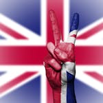 Illustration of a hand showing a peace sign with the UK flag background.